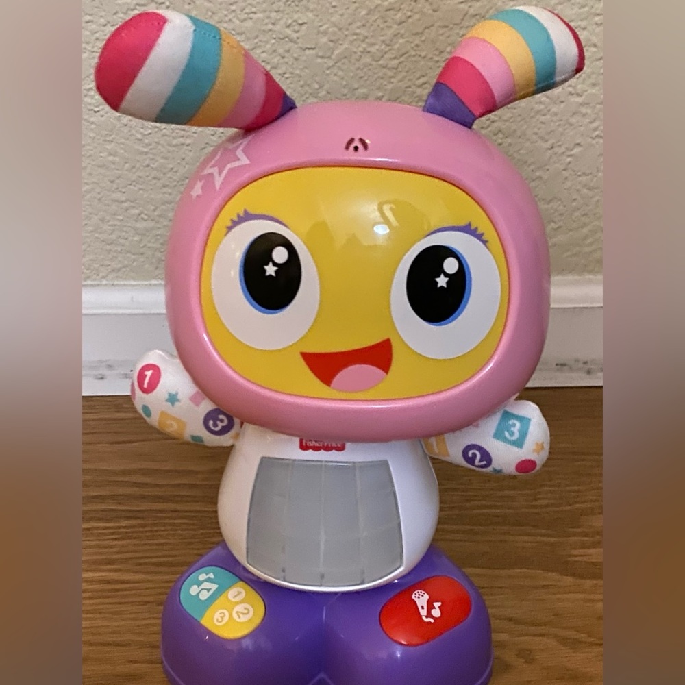 Fisher price robot dances and sings and copies what you say.